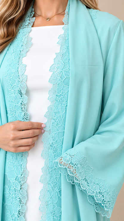 Close-up detail of the delicate scalloped lace trim on the neckline and sleeve cuff of aqua blue chiffon duster