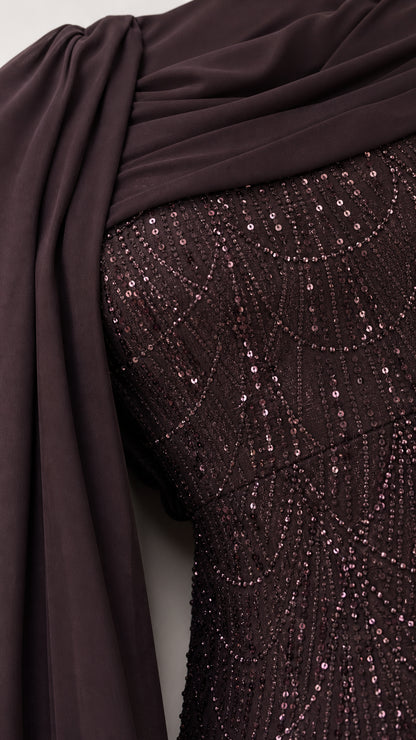 Close-up detail of textured sequin pattern and smooth draped chiffon cape fabric