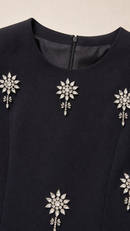 Close up of neckline and sparkling crystal rhinestone floral motif embellishments
