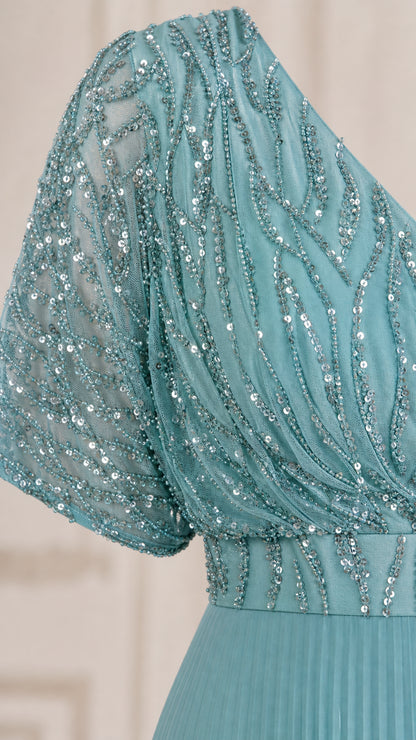 Close-up detail of teal blue sequin embroidery and flutter sleeve