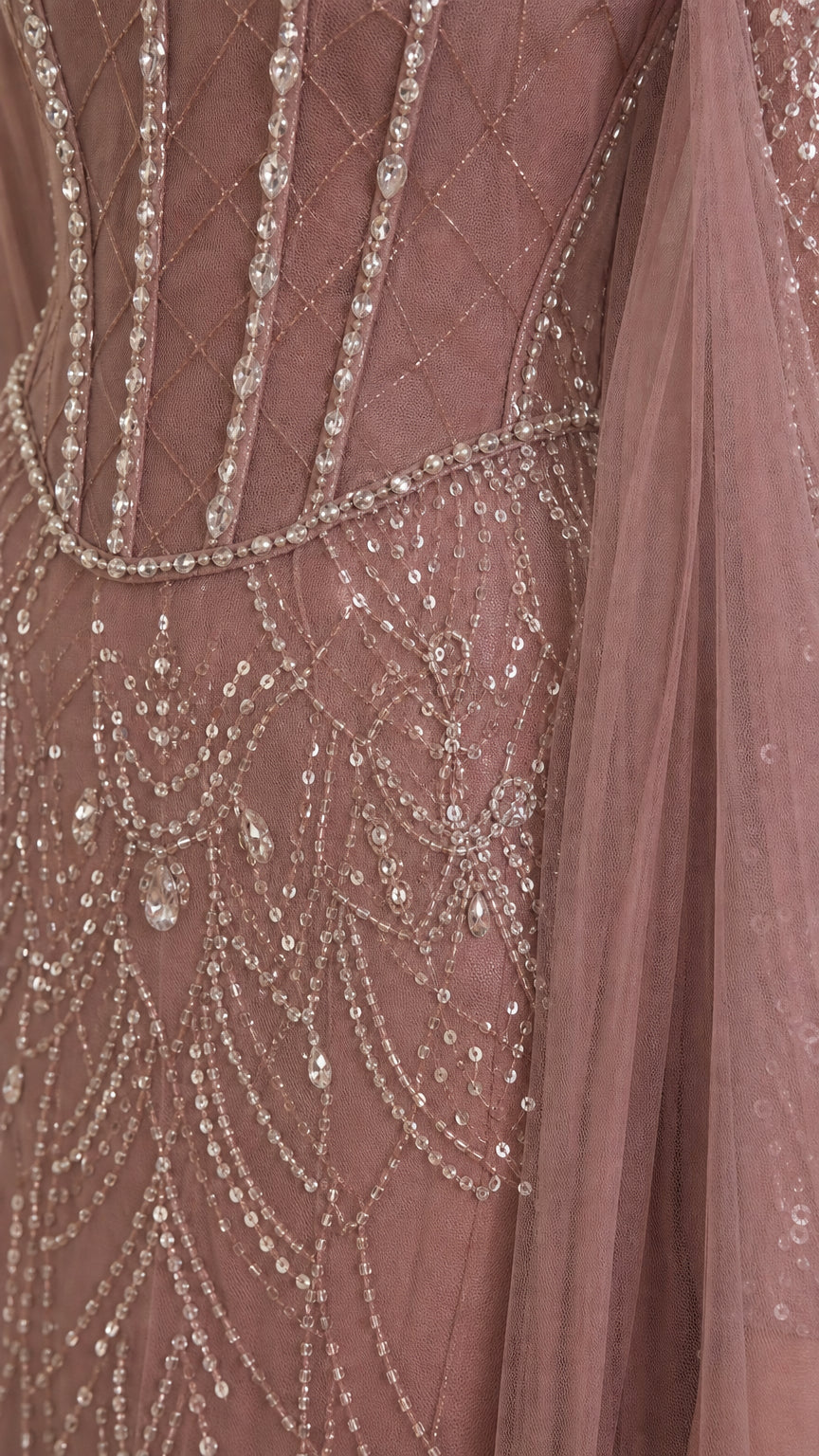 Close-up detail of bodice beadwork, corset lines, and sequin drape pattern