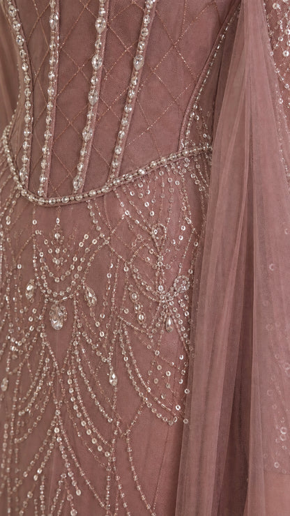 Close-up detail of bodice beadwork, corset lines, and sequin drape pattern