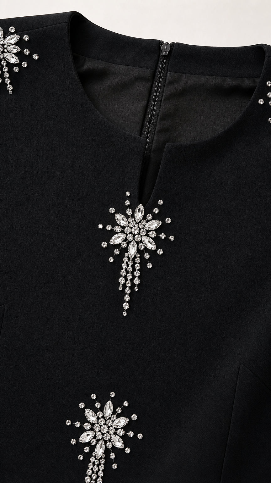 Close-up detail of neckline and crystal starburst rhinestone embellishments