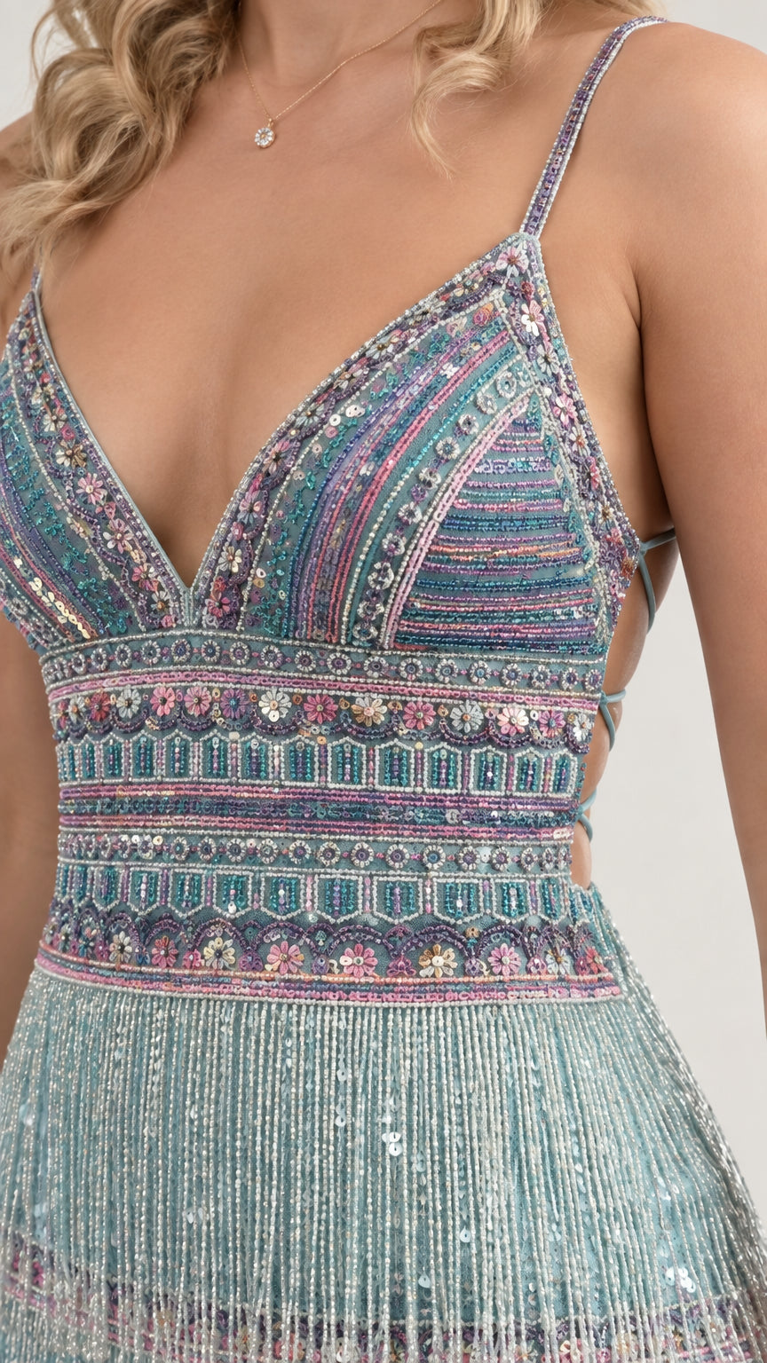 Close-up detail of geometric beadwork and dangling fringe hem