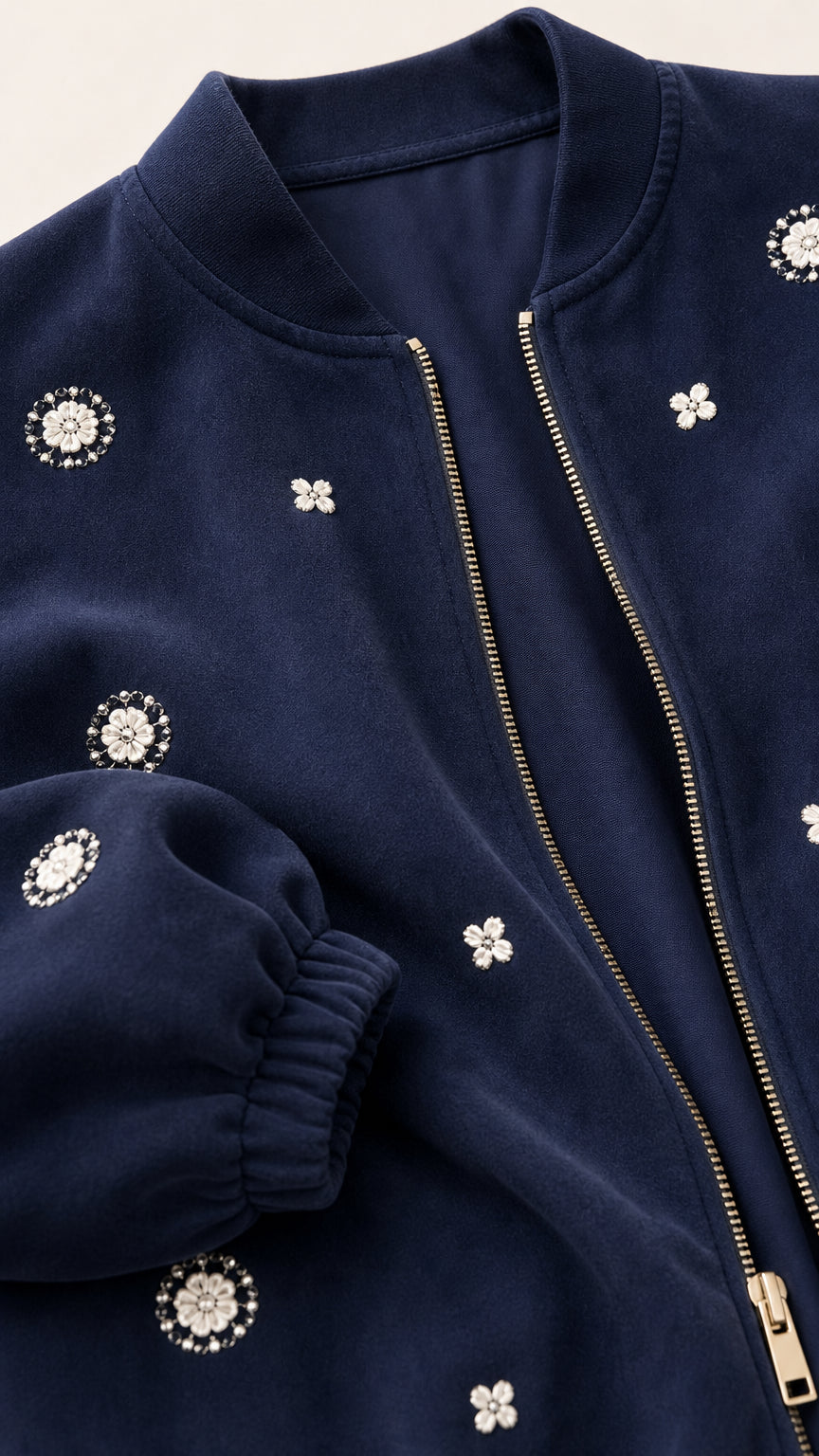 Close-up detail of Navy Blue bomber jacket showing zipper and pearl floral embellishments