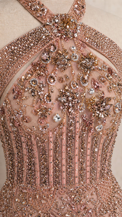 Close up detail of rhinestone, crystal, and beaded corset bodice on dusty rose gown