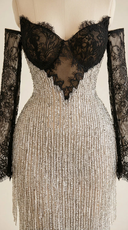 Close-up detail of black scalloped lace bustier and shimmering silver beaded fringe skirt