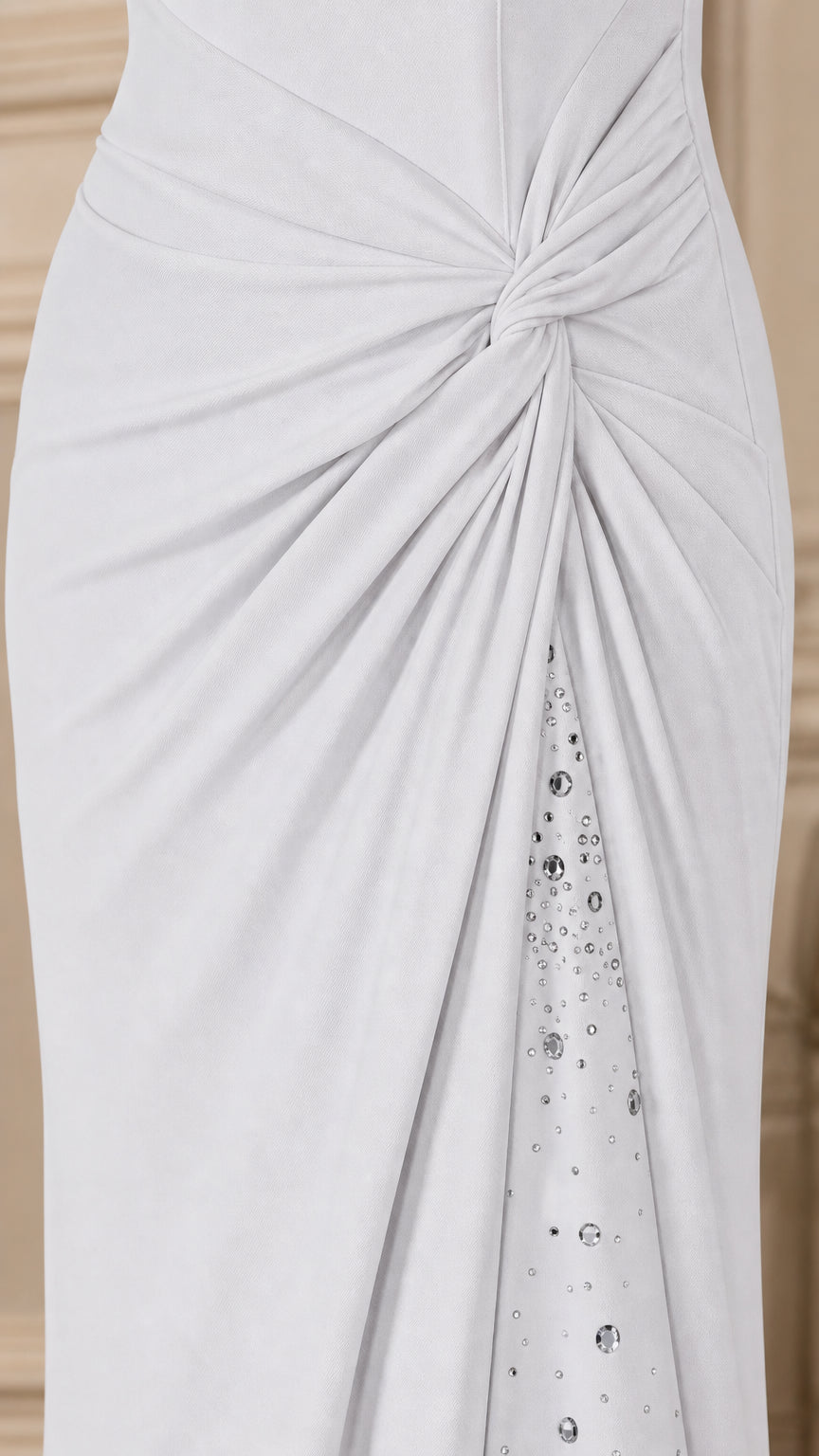 Close-up detail of side knot ruching and sparkling crystal trim