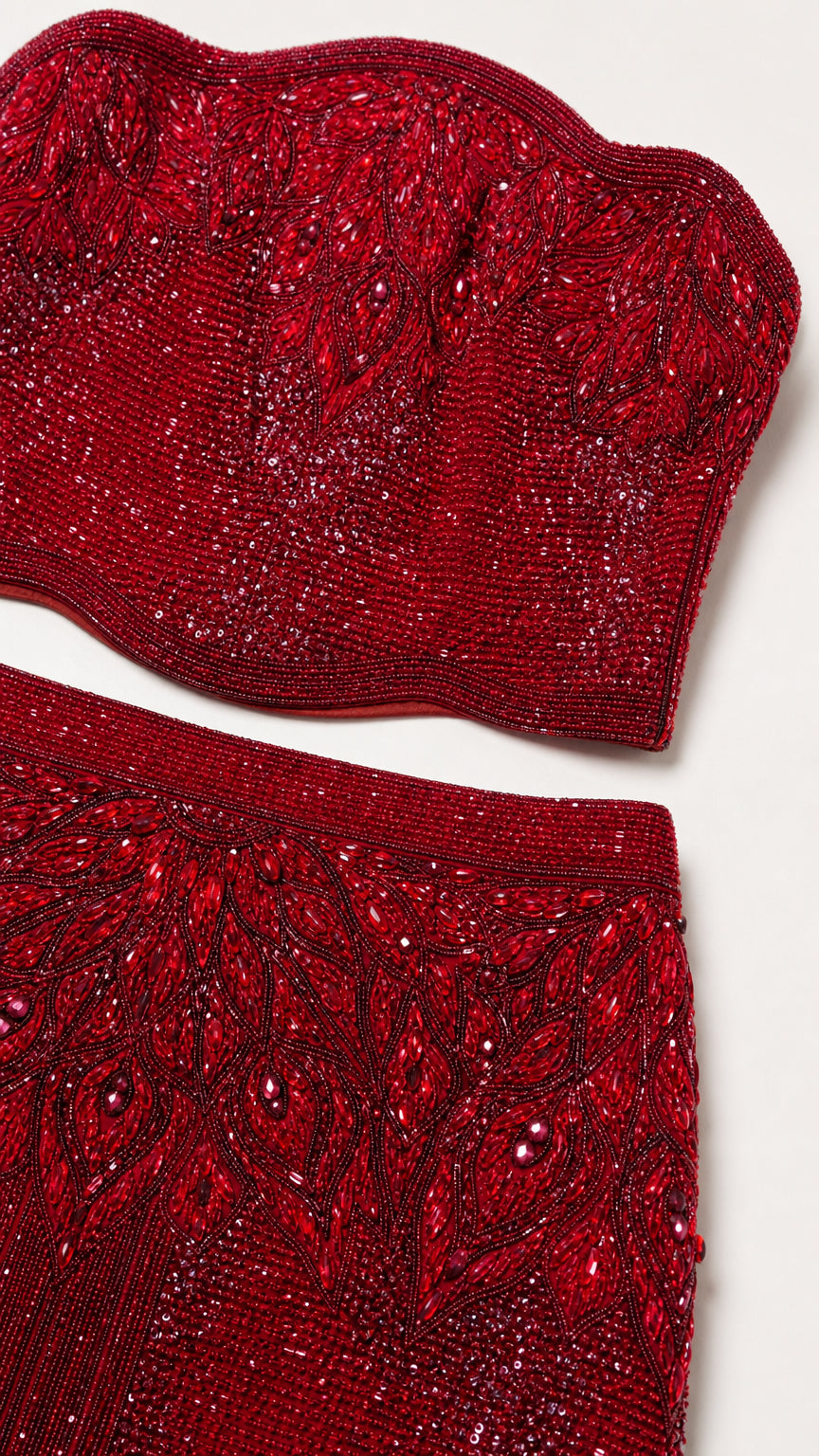 Close-up detail of intricate ruby red beadwork and embellished embroidery