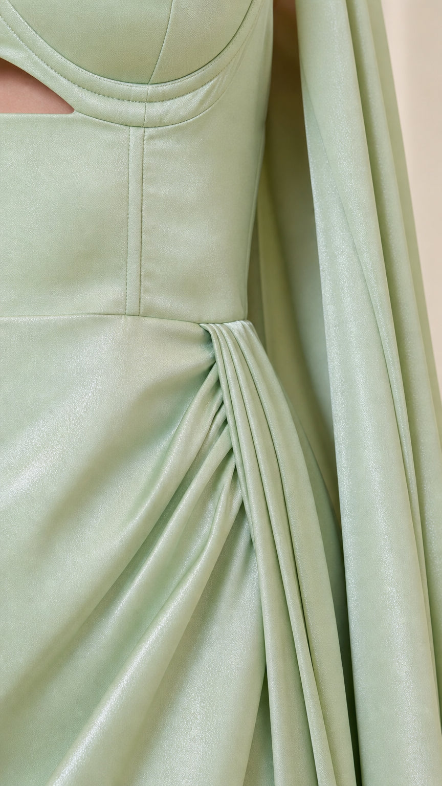 Close-up detail of structured bustier seam, cutout, and pleated skirt fabric