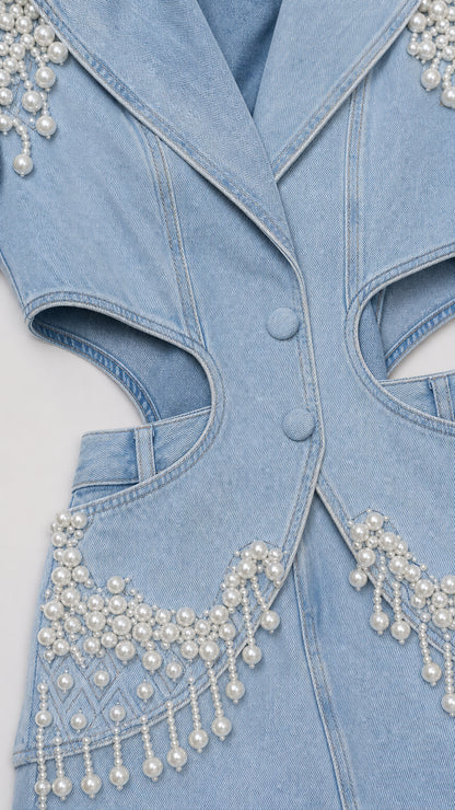 Close-up detail of denim texture, lapels, buttons, and intricate faux pearl fringe
