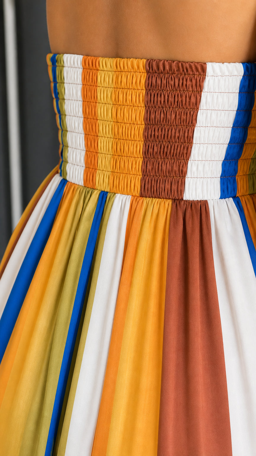 Close-up detail of smocked back panel and striped woven fabric