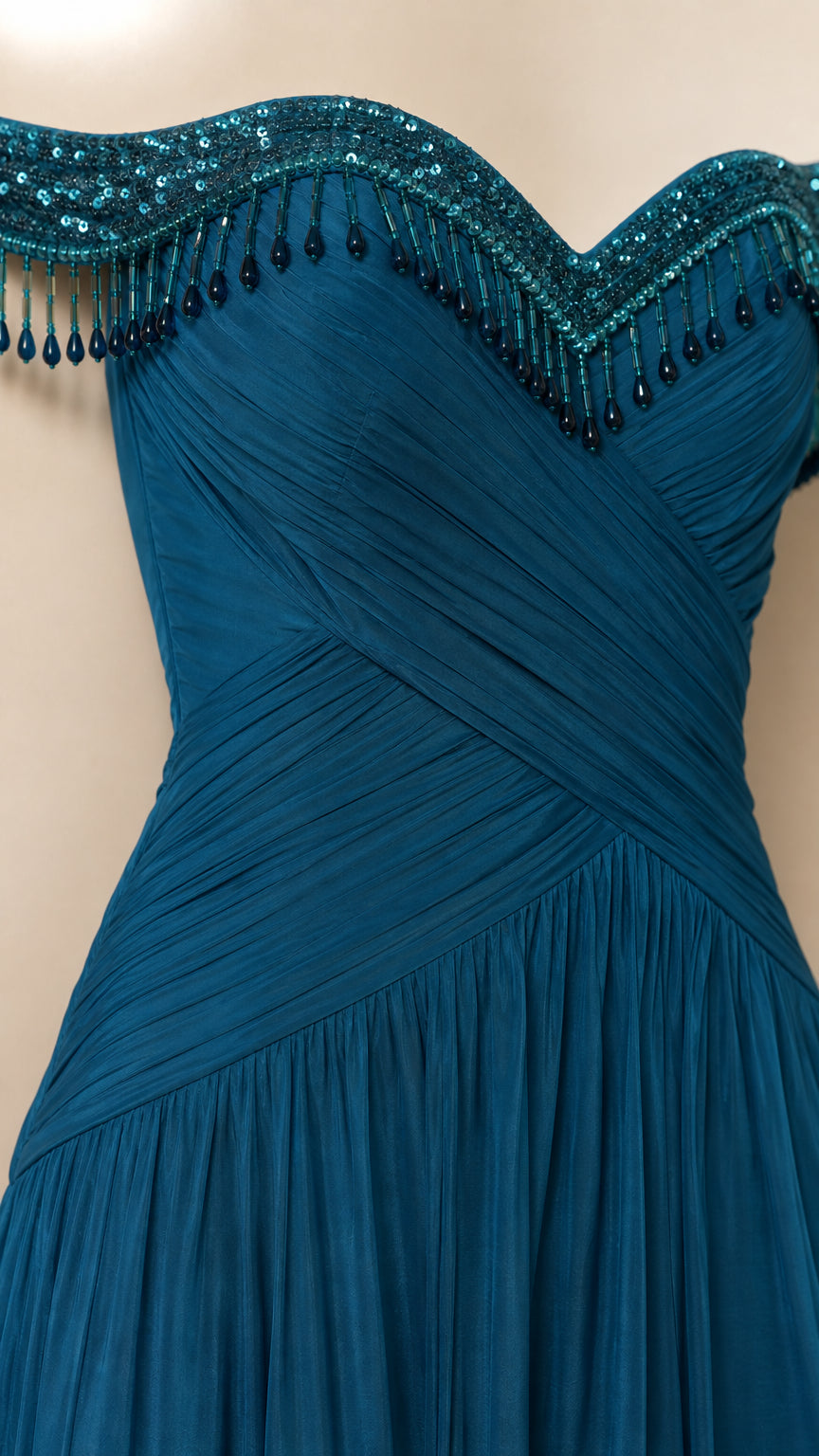 Close-up detail of beaded fringe embellishments and ruched sweetheart neckline in teal blue