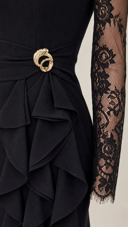 Close-up of waist buckle brooch and layered vertical cascade ruffles