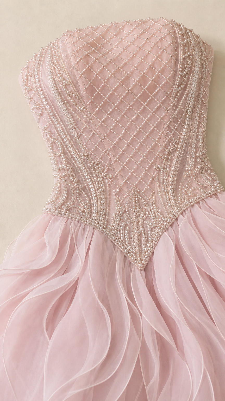 Close-up detail of blush pink lattice pearl and crystal beaded corset bodice