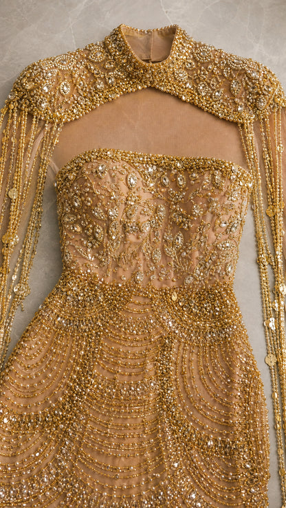 Close up detail of intricate gold beadwork, sequins, and fringe neckline