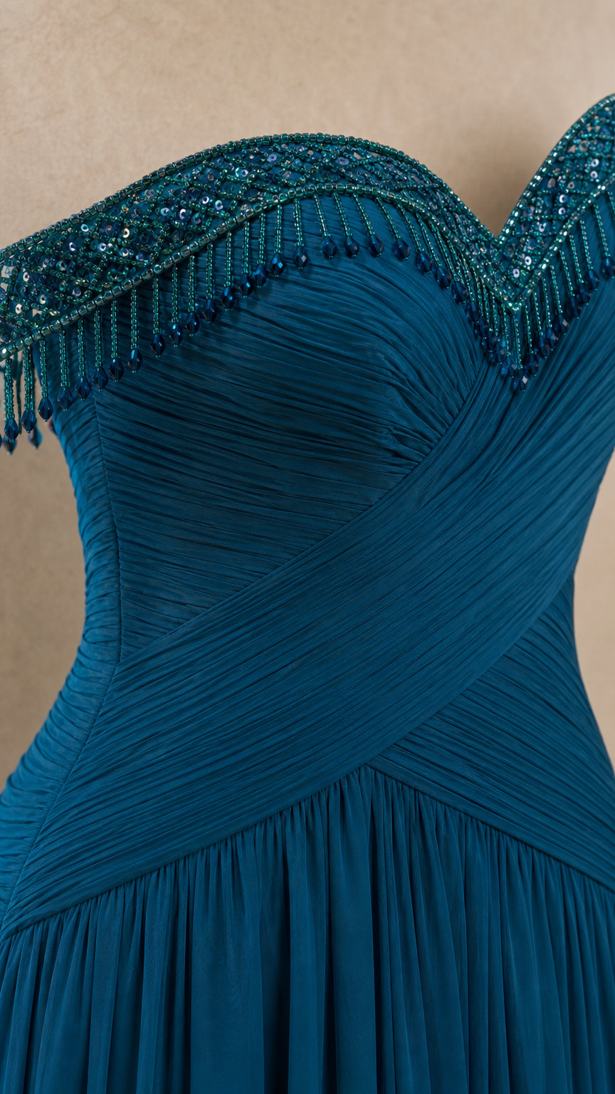 Close-up detail of teal ruched bodice with intricate beaded fringe along the sweetheart neckline