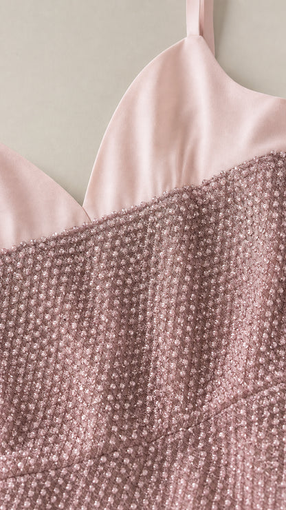 Close-up detail of smooth satin-finish neckline and textured shimmer fabric in dusty rose