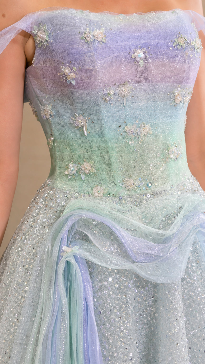 Close-up detail of bodice with 3D floral appliqués, beading, and soft pastel ombre fabric