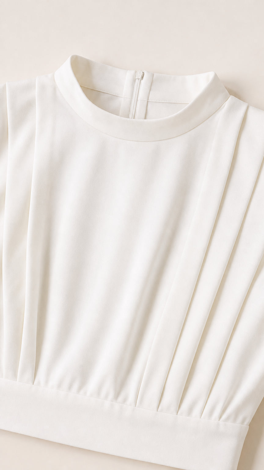 Close-up detail of white mock neckline with vertical pleating and clean finish