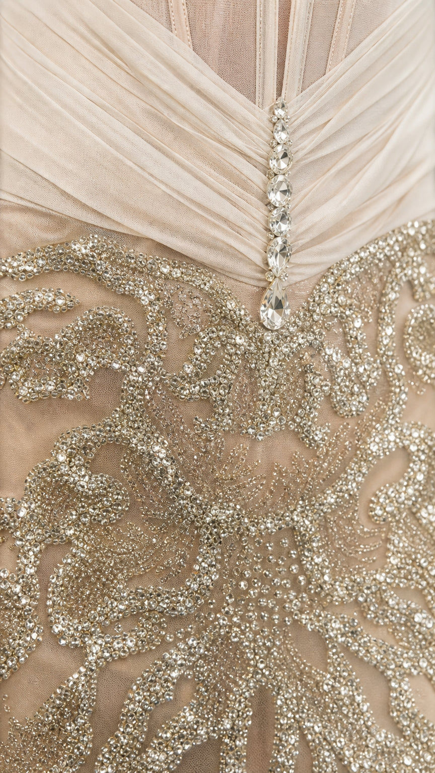 Close up of gathered bustier, crystal drop trim, and metallic sequin embroidery