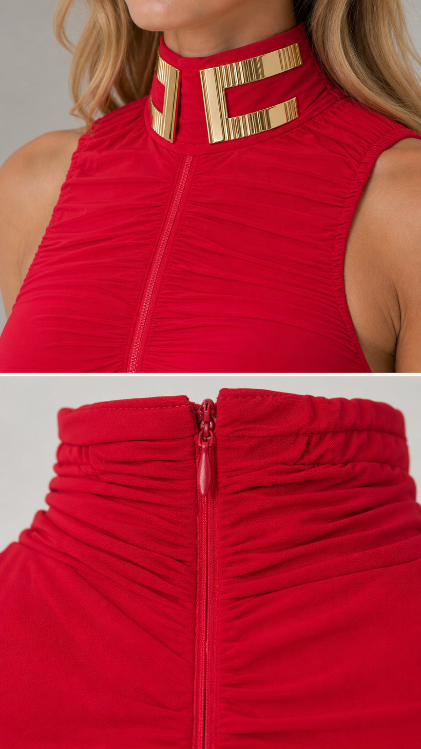 Close-up detail of the gold-tone metallic collar hardware and zipper on the red dress