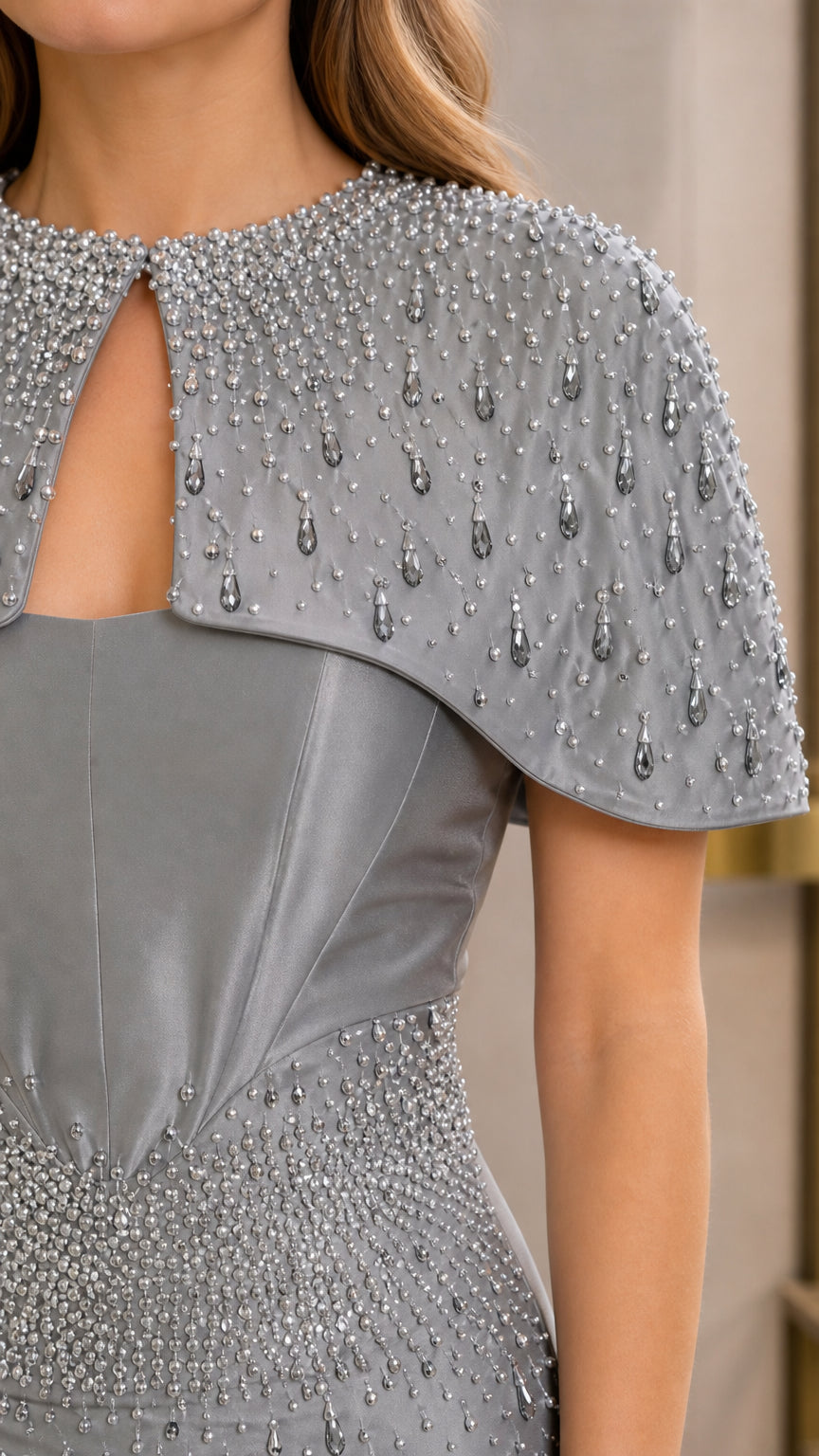 Close-up detail of teardrop beading and neckline cutout on Silver Gray capelet