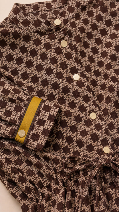 Close-up detail of Coffee Brown geometric print fabric, collar, gold-tone buttons, and contrast cuff trim