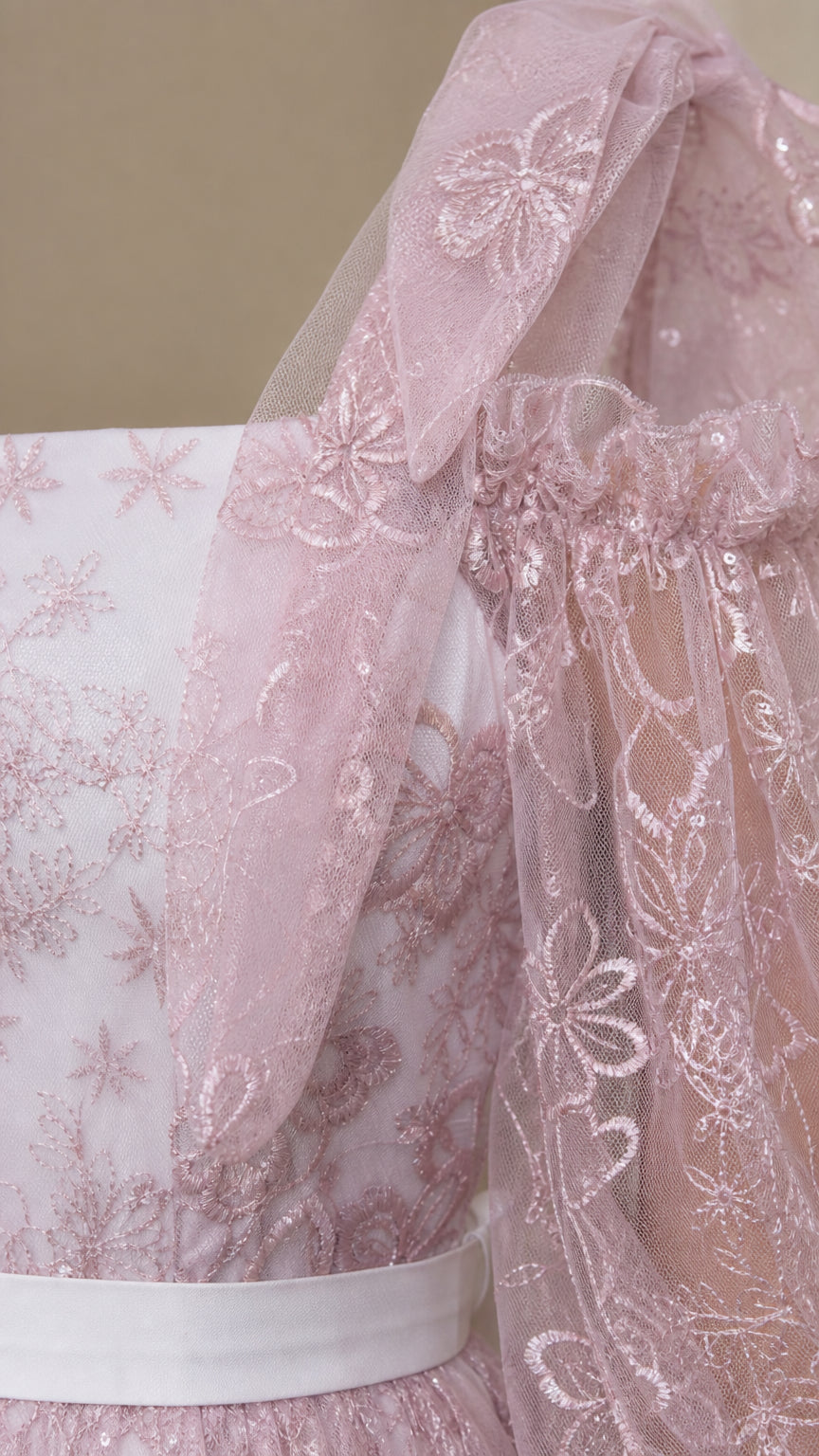 Close-up detail of dusty pink embroidered tulle floral lace and cold shoulder strap