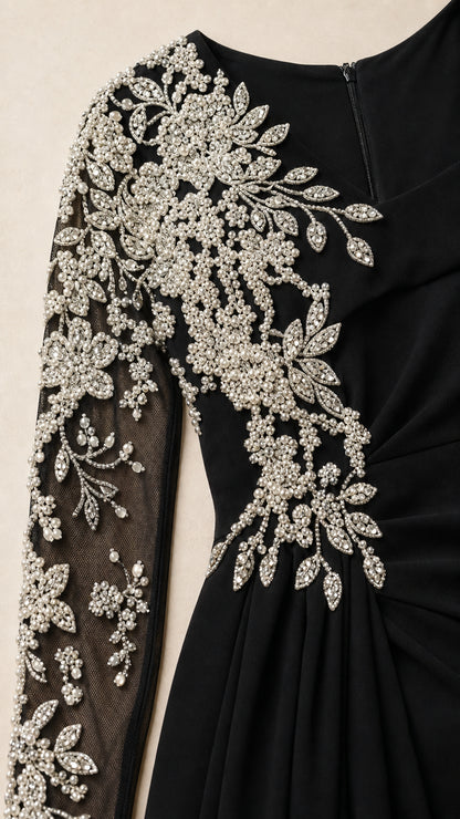 Close-up detail of silver crystal floral beading on sheer illusion sleeve and bodice