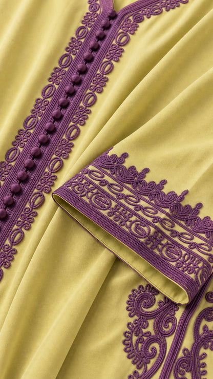 Close-up detail of purple embroidered trim and fabric-covered buttons on lime green dress