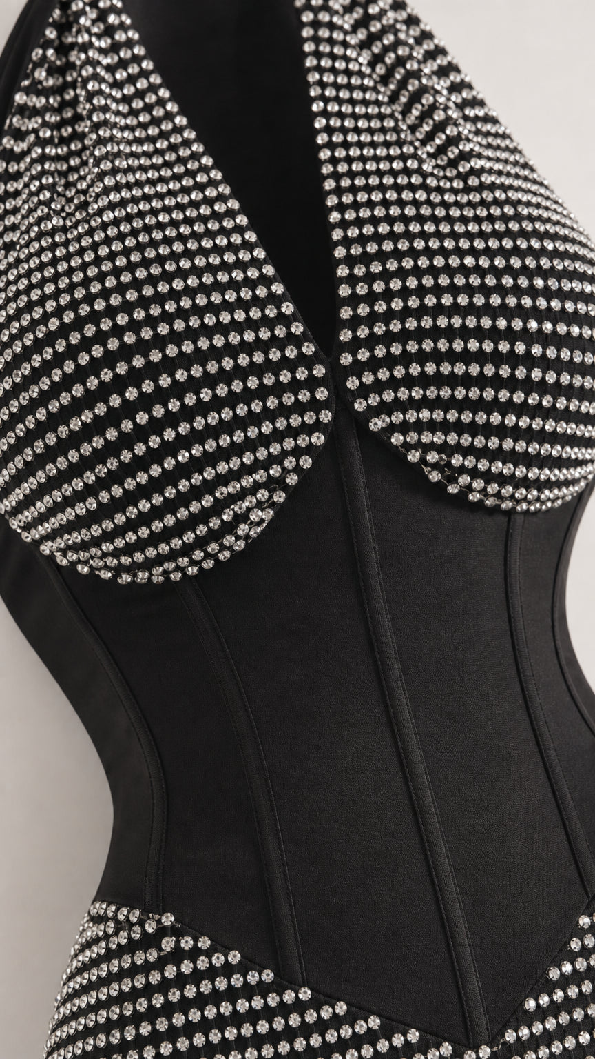 Close-up detail of rhinestone studs and structured corset boning on black dress