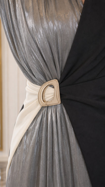 Close-up detail of silver shimmer pleating and buckle waist accent