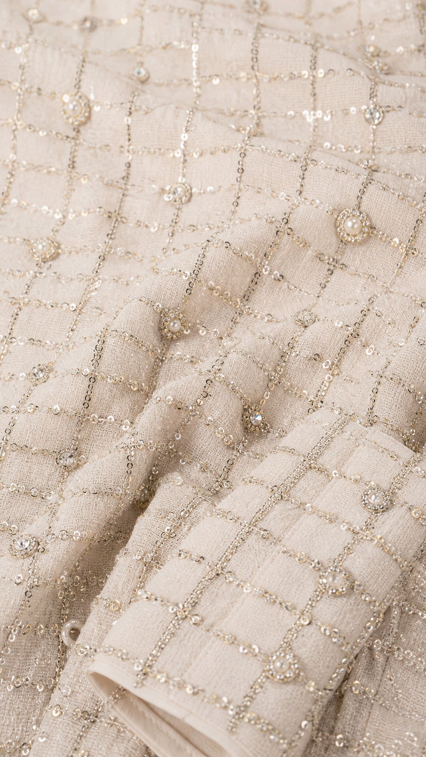 Close-up detail of the shimmering grid tweed fabric with metallic threading and delicate beading
