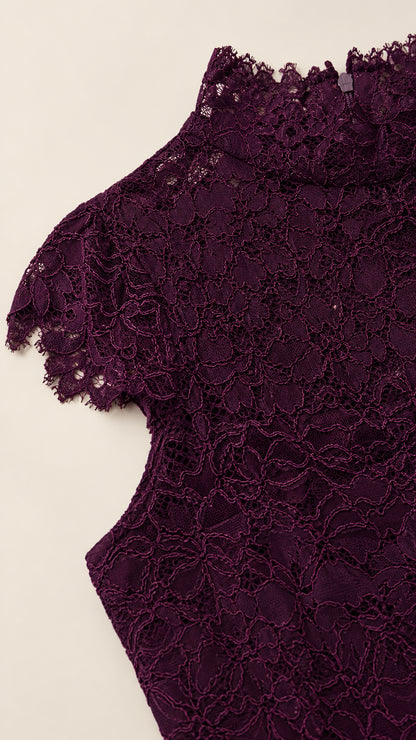Close-up detail of the high mock neck and scalloped cap sleeve lace
