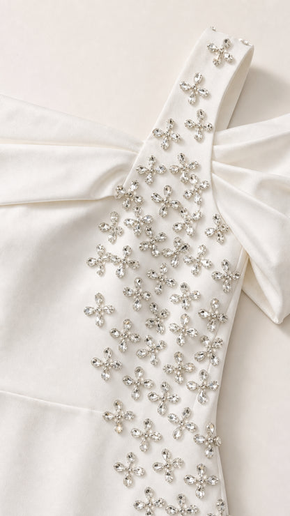 Close-up detail of sparkling crystal floral embellishments on shoulder strap and bodice