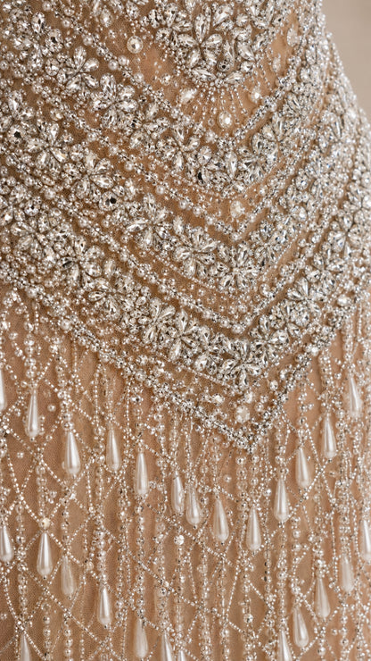 Close-up detail of rhinestone embroidery and droplet pearl beadwork