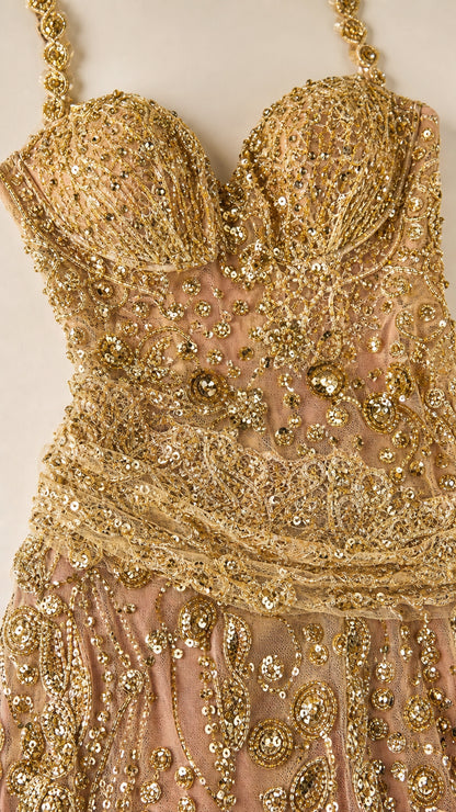 Close-up detail of sweetheart neckline and intricate gold beadwork and sequins