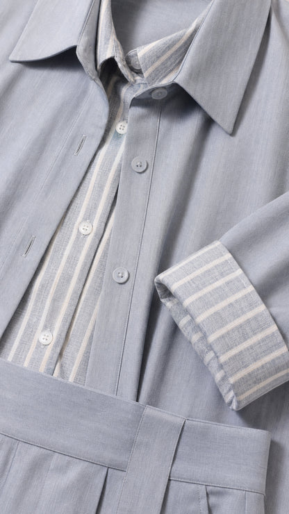 Close-up detail of the striped button-down collar, duster cuff, and pleated waistband