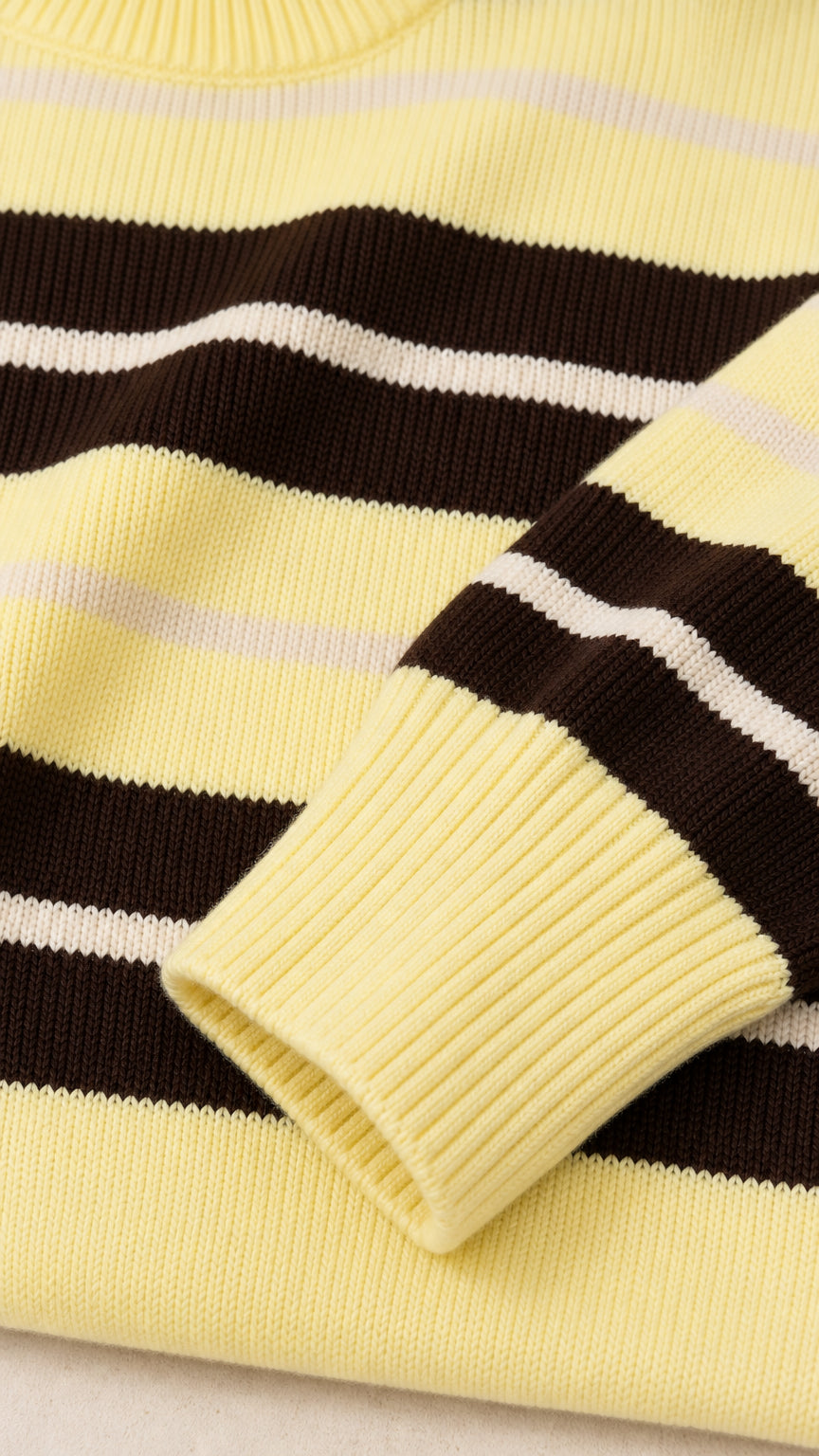 Close-up detail of knitted fabric, striped pattern, and ribbed sleeve cuff
