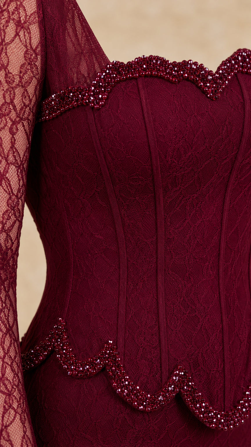 Close-up detail of burgundy beaded scalloped trim and corset boning on lace gown