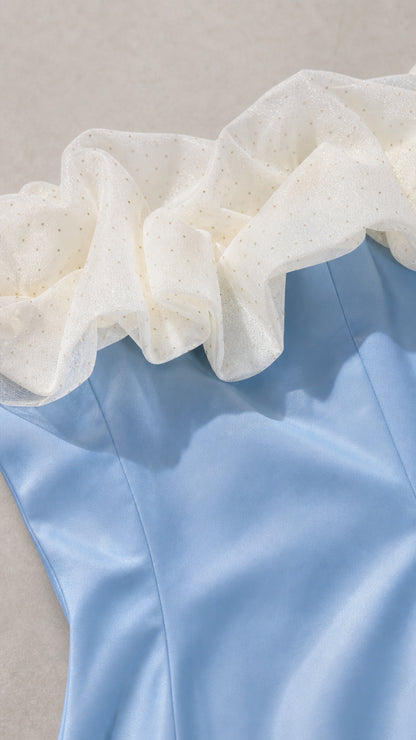 Close-up detail of textured dotted ruffle trim on off-the-shoulder neckline