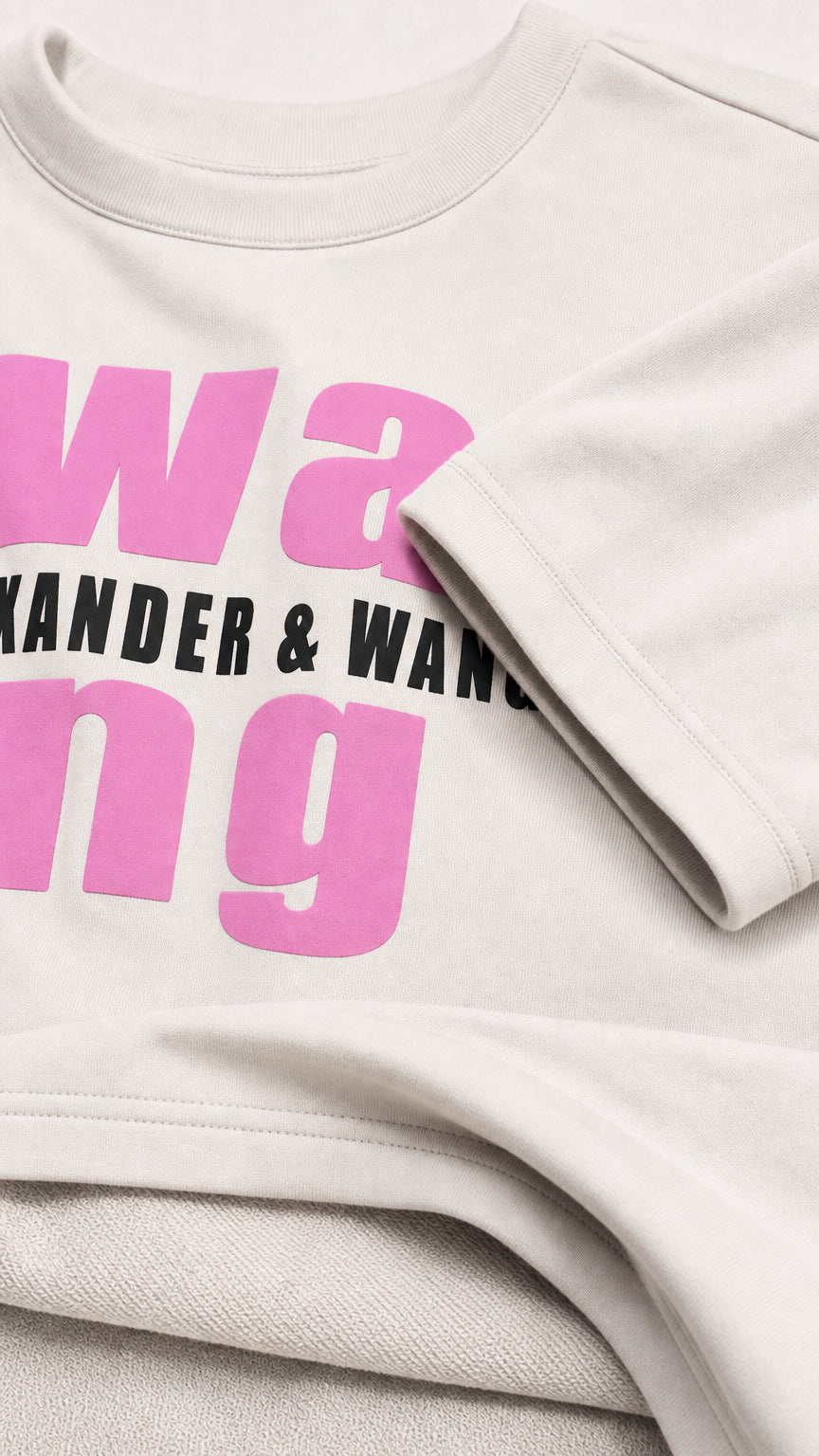 Close up detail of graphic print, ribbed crew neckline, and soft knit fabric