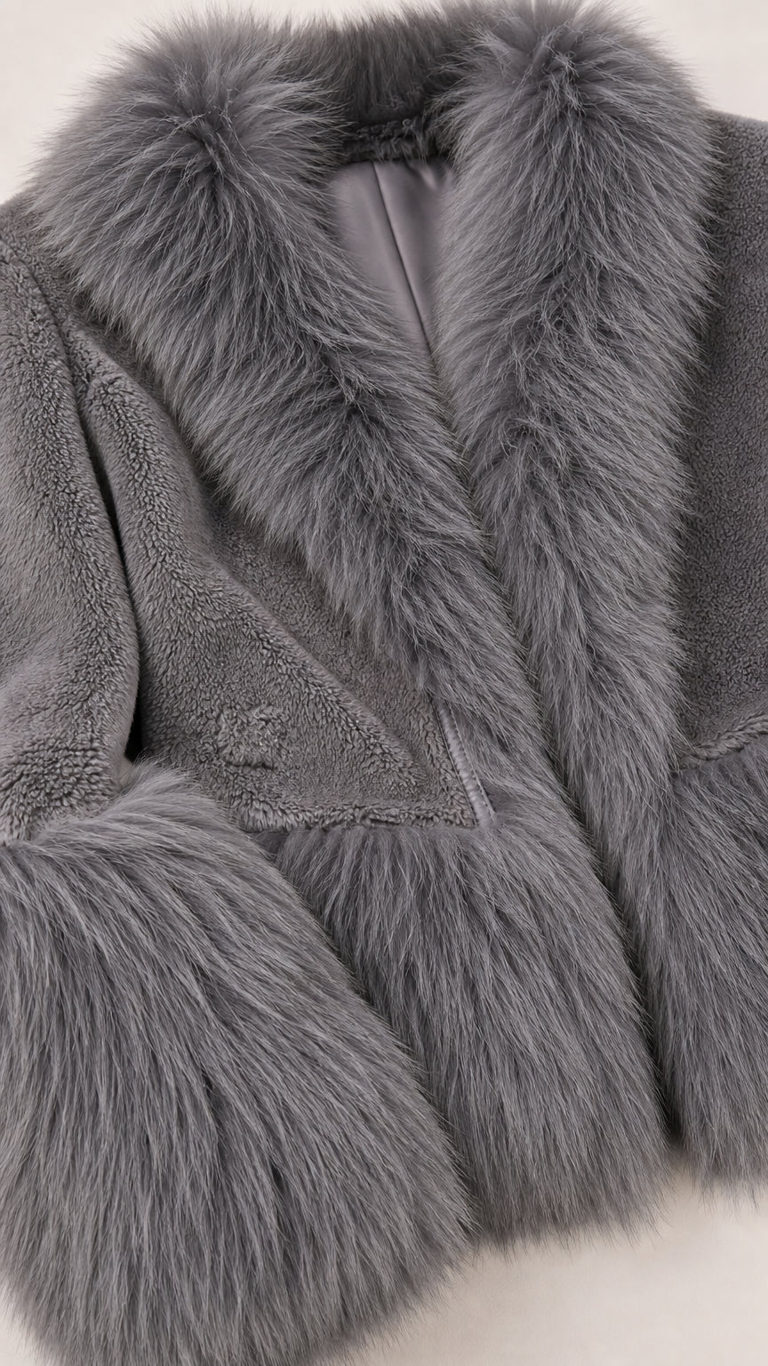 Close-up detail of grey faux fur lapel, lining, and textured plush body