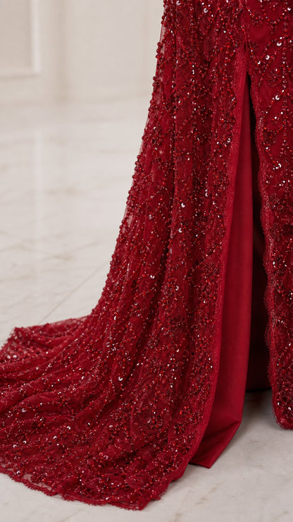 Close-up detail of ruby red sequin and bead embroidery on gown hem