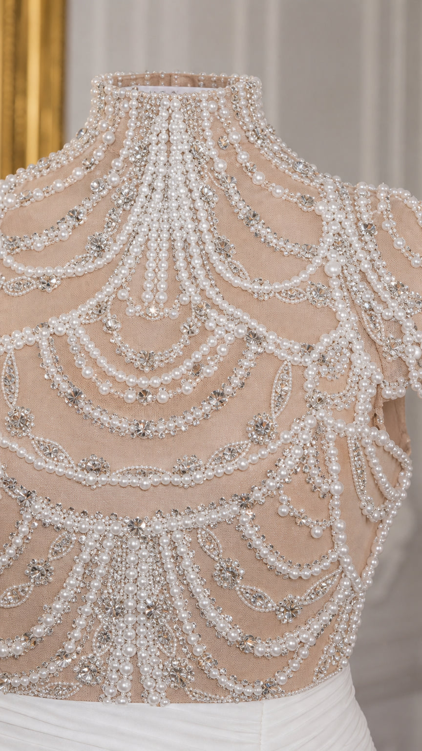 Close-up of intricate pearl and crystal beading on high mock neck sheer bodice