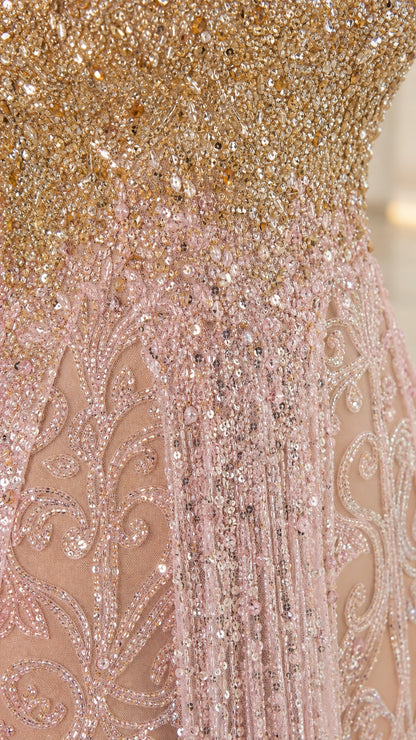 Close-up detail of intricate gold-to-pink ombré beadwork and embroidery