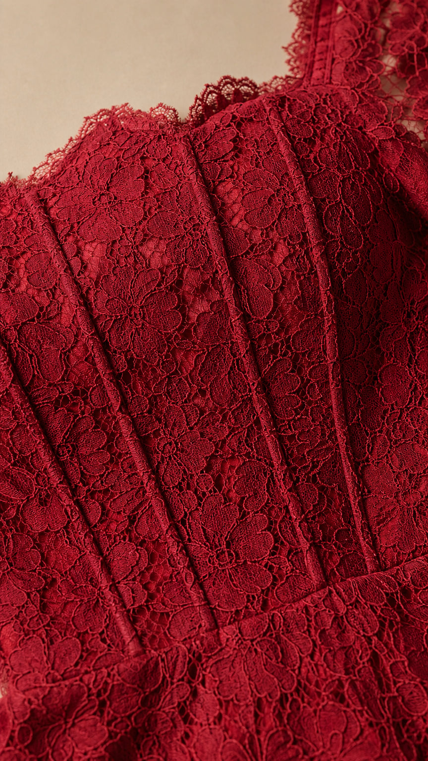 Close-up detail of burgundy floral lace texture and corset bodice boning
