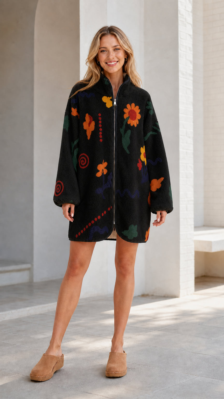 Front view of a black women's floral printed fleece zip-up jacket