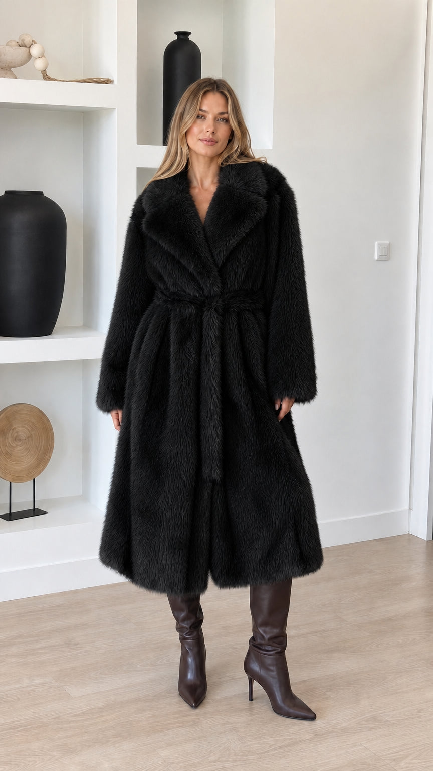 Full-length view of model wearing black plush faux fur belted wrap coat